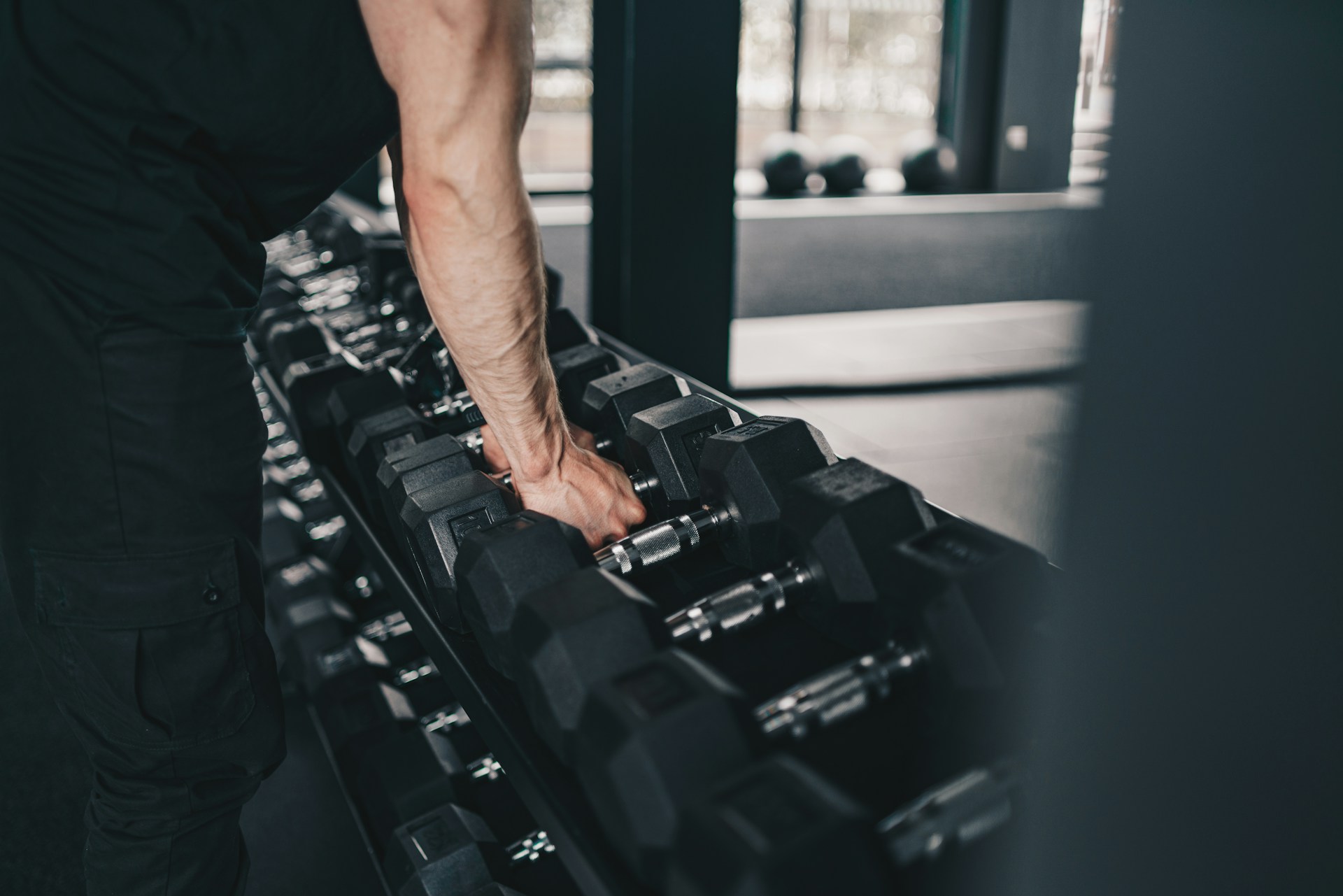 Gym dumbbell rack in moody lighting